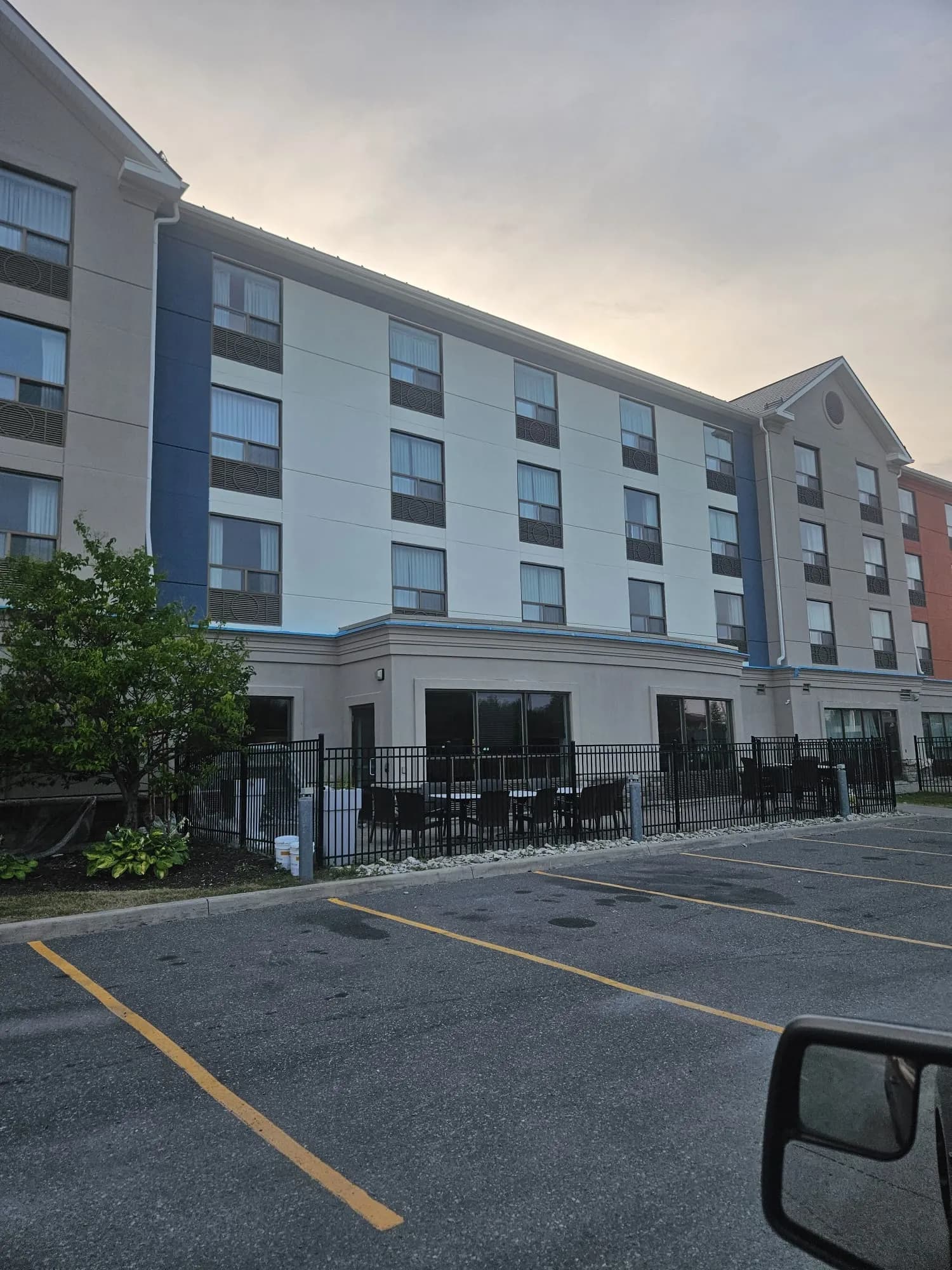 Holiday Inn Express, New Liskeard — White guest room wing and the blue-grey panel above the patio
