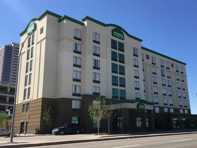 Wingate by Wyndham, Regina — Before: the hotel in tan stucco with green trim