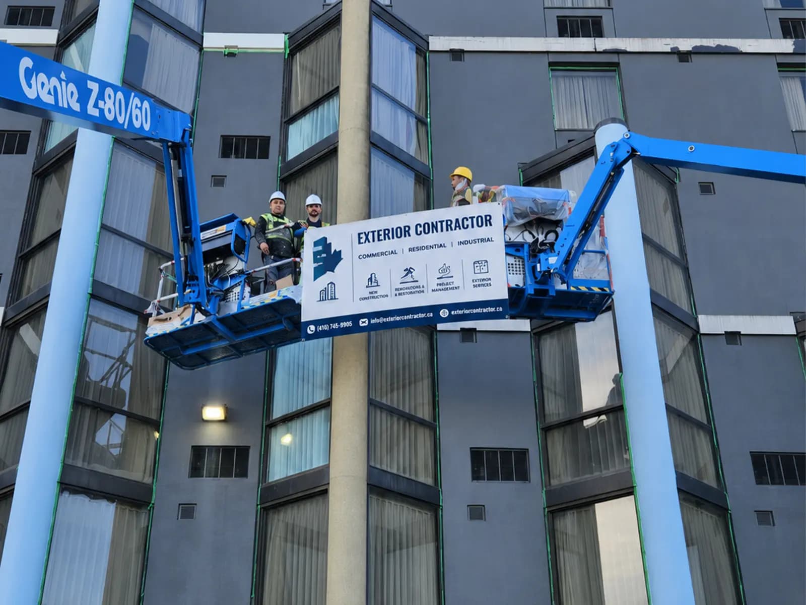 Maple Build crews working an occupied hotel exterior from boom lifts