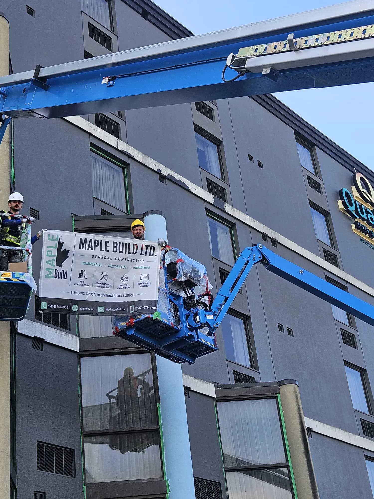 Quality Inn, Sault Ste. Marie — Crew in the basket with the Maple Build banner, cutting in at the banding