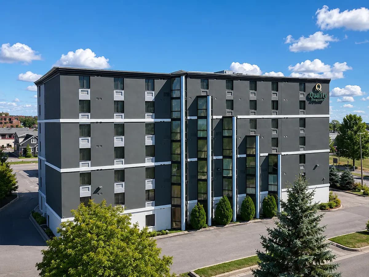 Five-storey hotel finished in dark stucco with white banding, Sault Ste. Marie
